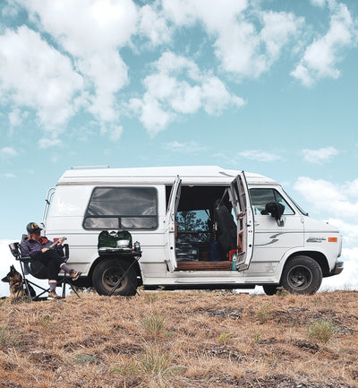 Christina Deubel sits with her van the Wilma Pearl and her German Shepherd on one of her many Van Life Adventures.